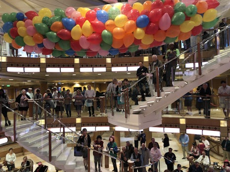 Balloons about to drop in ships atrium celebrating the cruise.