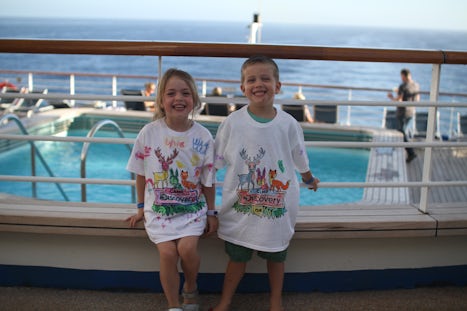Grandchildren proudly showing off T-shirts they decorated in Kid’s Club