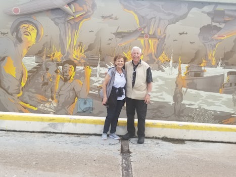 Joyce and Louie standing in from of "Bombing of Darwin" mural which