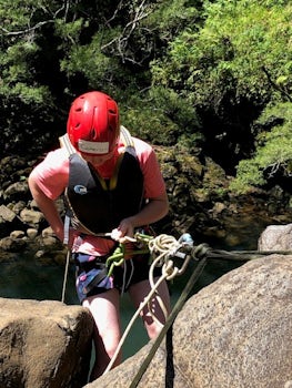 My son getting ready to rappel down next to the waterfall