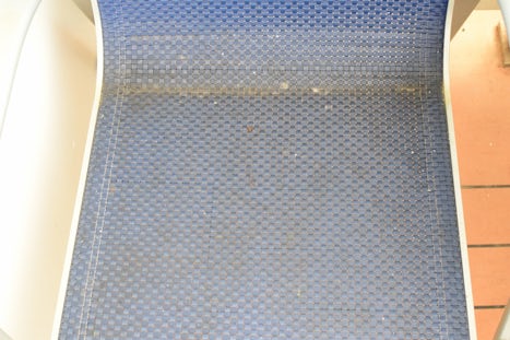 Stained and dirty chair on balcony.