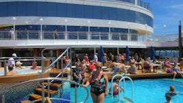 I am standing by one of the two pools on the NCL Pearl enjoying the music a