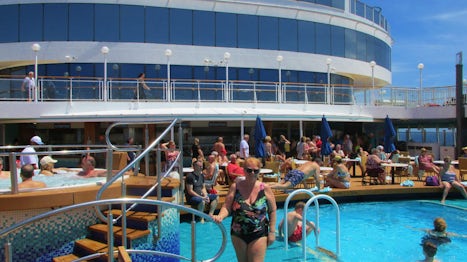 I am standing by one of the two pools on the NCL Pearl enjoying the music a