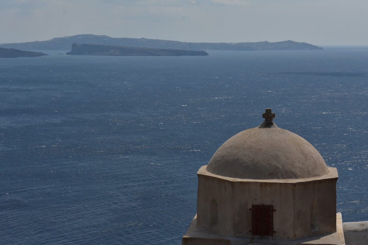 The top of an old church and the bay in Santorini