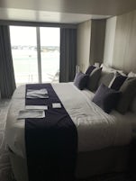 Bed and balcony door of cabin 11274 or the Celebrity Edge.