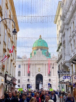 A street scene in Vienna, Austria with the green dome of St. Michael&#39;s.