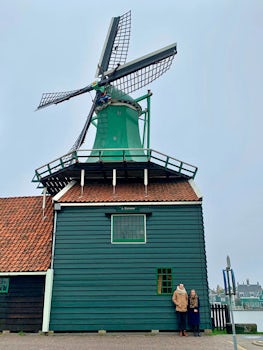 A couple taking a break in front of a windmill at Zaanse Schans.