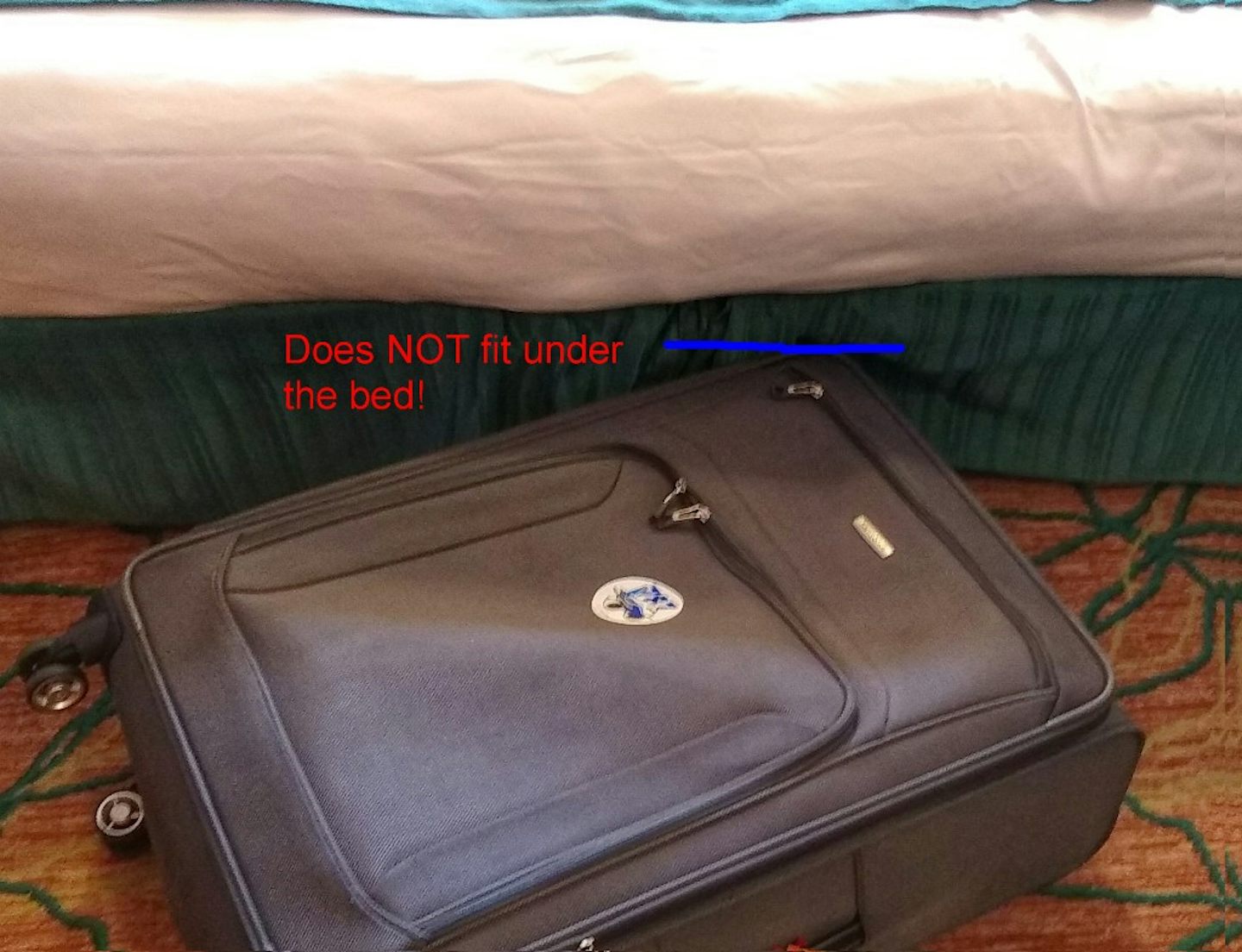 Suitcase will not slide under the bed, which is actually two cots pushed to