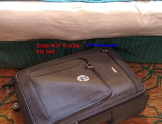 Suitcase will not slide under the bed, which is actually two cots pushed to