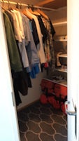 Walk in closet with generous hanging space and shelves in cabin 1350. 