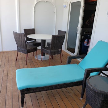 Deck with two lounge chairs and table.  Breakfast on the deck was a great w