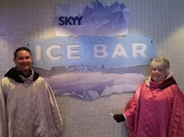 Outside the Ice Bar, wearing the capes provided.