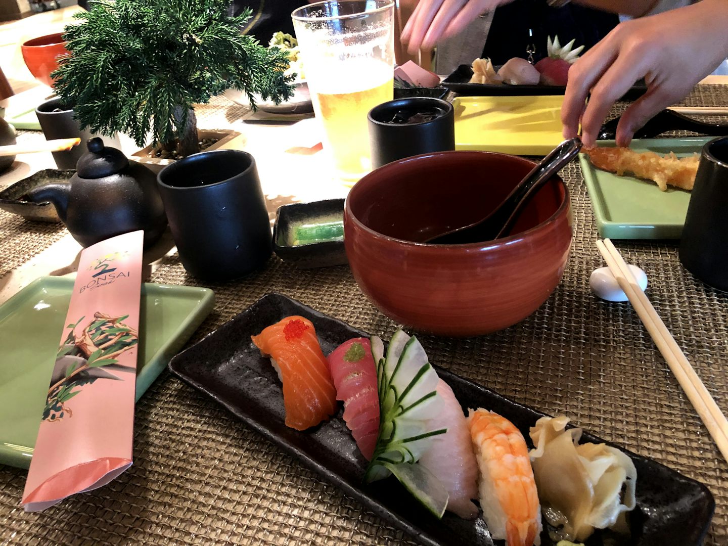 Nigiri and miso soup at Bonsai Sushi. The little teapot by the bonsai plant