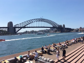 Sydney bridge with people walking across the top.