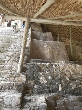 Steps and original masks at the temple at the Kohunlich Mayan Ruins