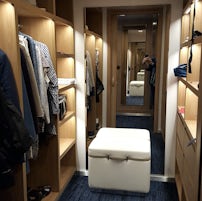 Ample hanging space, shelves and drawers in walk in robe in Privilege Suite