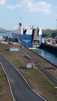 Cargo ship passing thru Miraflores locks guided by electric &#39;mules&#39;