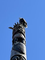 A bald eagle on top of totem pole on  Totem Bight State Historical Park