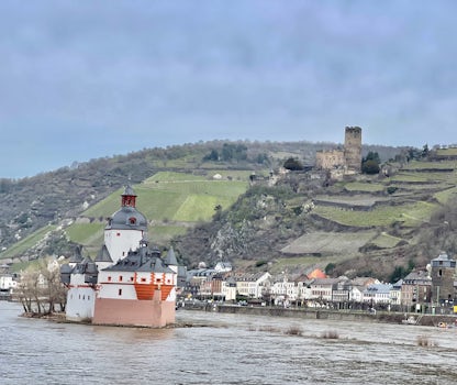 Two castles along the Rhine river valley. One is the island and another one up on the hill.
