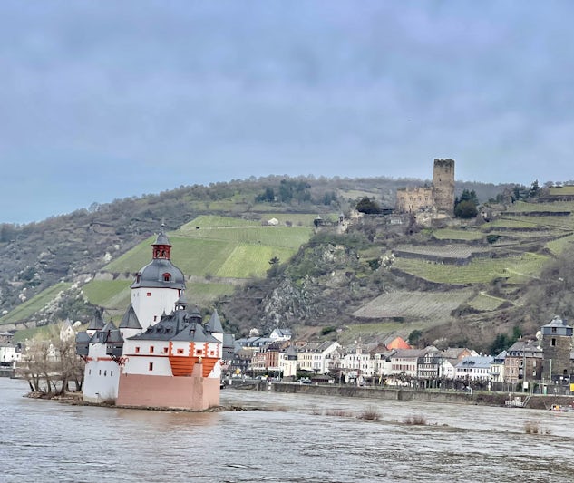 Two castles along the Rhine river valley. One is the island and another one up on the hill.