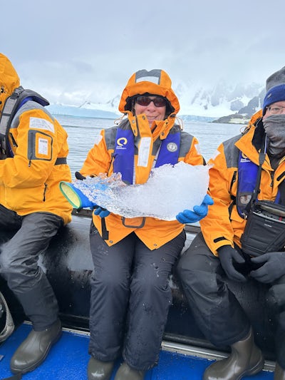 Holding a piece of ice on a zodiac excurision.
