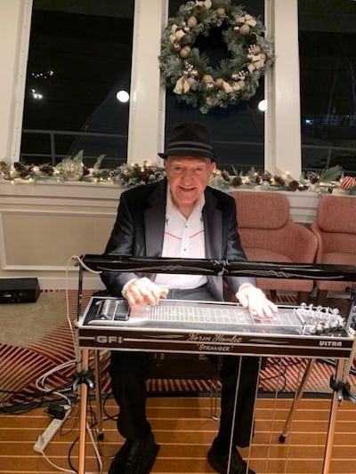 Ship musician (part of the Mario and Norm duo) Norm Hamlet on steel guitar. He was the bandleader for Merle Haggard for 49 years!