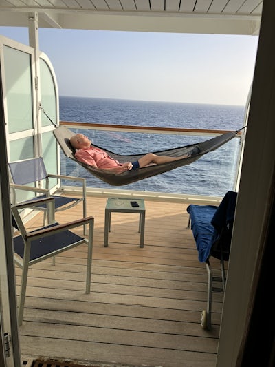 My husband relaxing in the hammock on our balcony