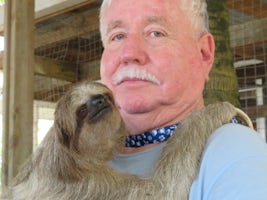 Mike holding a sloth
