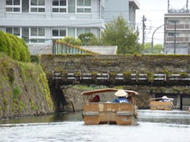 Matsue river cruise. Note lowered roof to get under bridge