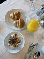 Breakfast in main dining. Freshly squeezed orange juice, granola parfait blueberries and croissant. Very happy for this and coffee. 
