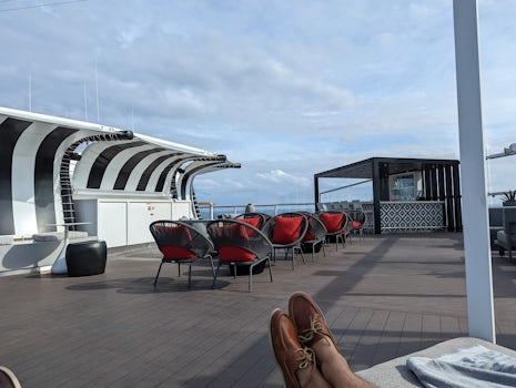 Retreat Deck on Celebrity Silhouette in the afternoon. Bar is unstaffed and the crew has disappeared.