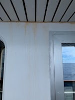 Rust water on the wall outside balcony door