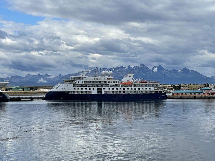 The Ocean Explorer in Ushuaia port with a backdrop of the Andes.