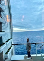 Photo of my husband standing on the veranda at sunset. 